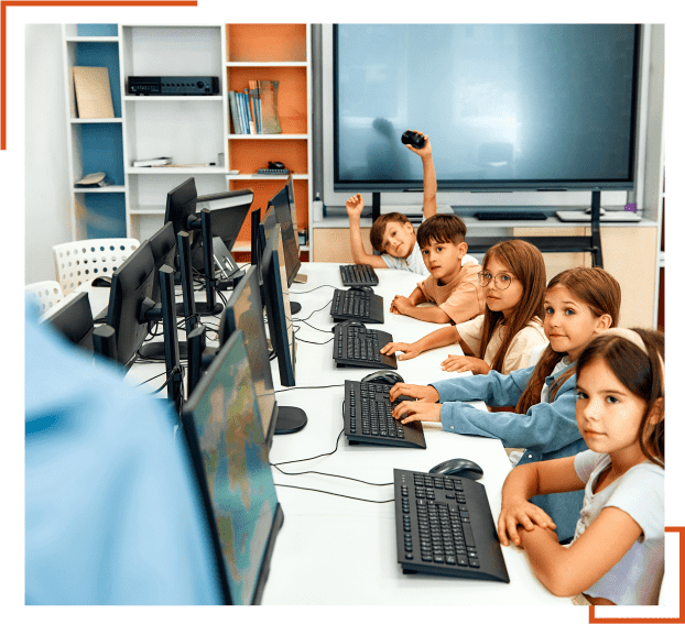Children learning computers in a classroom setting.