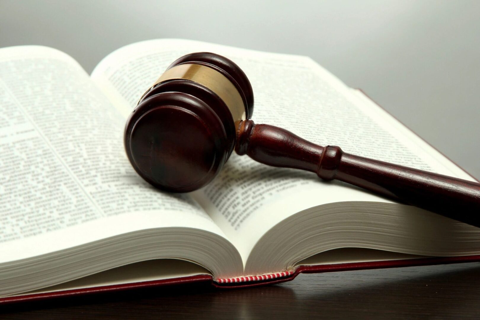 A wooden gavel resting on an open book.