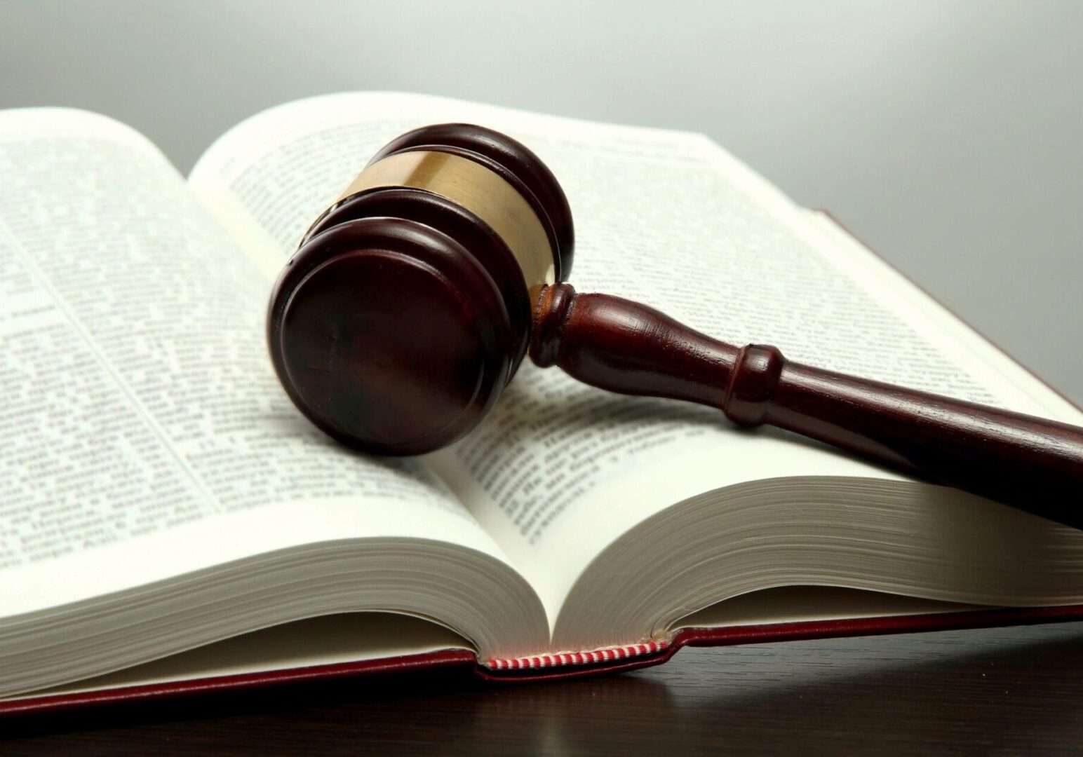 A wooden gavel resting on an open book.